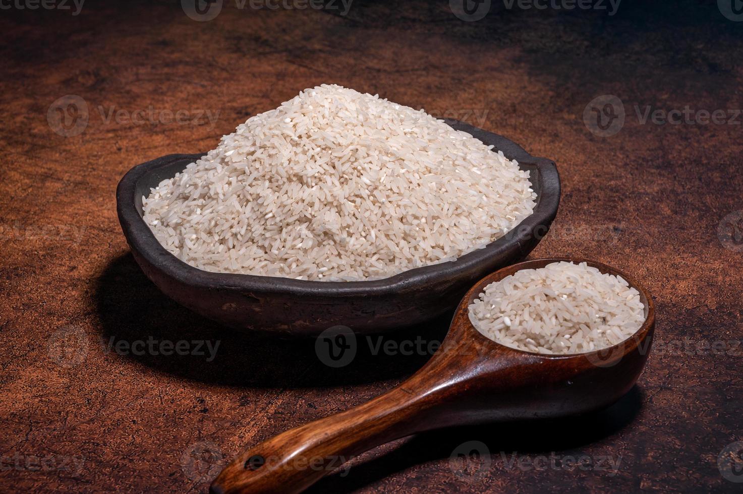 The white rice in the bowl is on the dark background photo