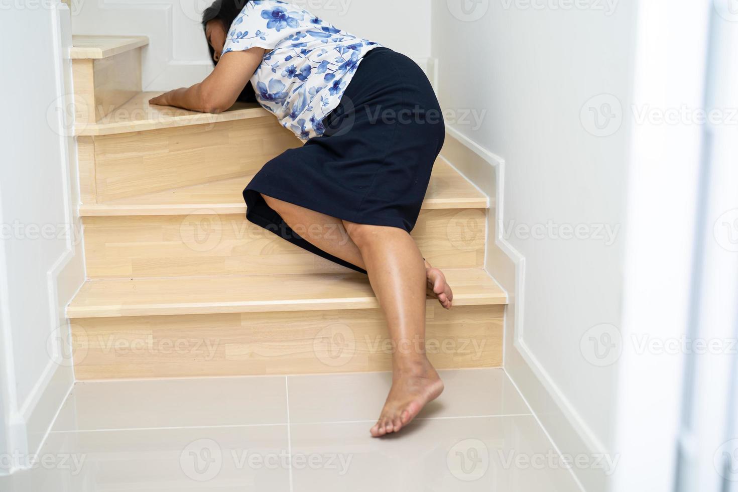 Asian middle-aged lady woman patient fall down the stairs because slippery surfaces photo