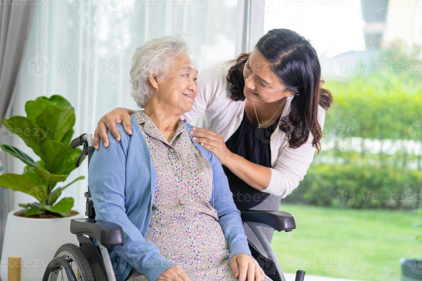 Caregiver daughter help Asian senior or elderly old lady woman sitting on wheelchair. photo