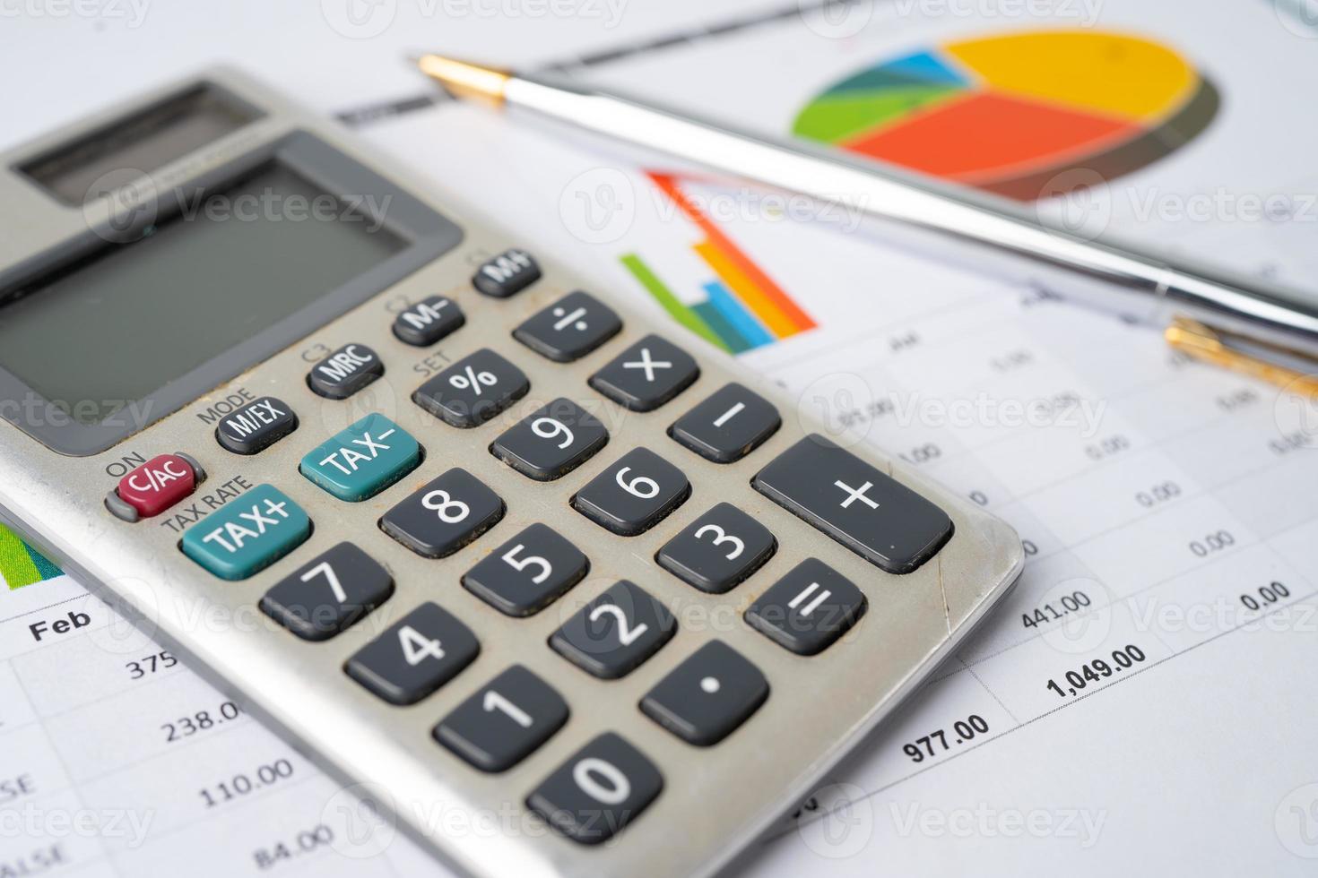 Calculator with pen on chart graph paper, finance, account, statistic, analytic economy Business concept. photo