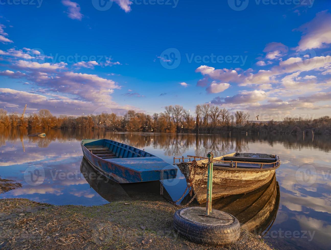 Old yellow boat on the lake photo