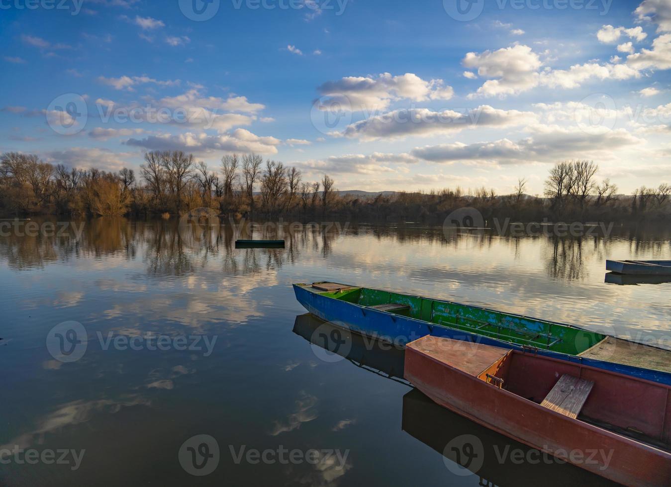 Small boats on the calm lake photo