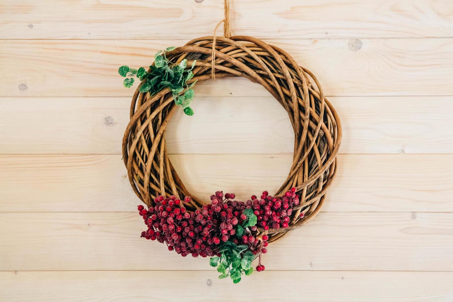 Round wicker wreath of branches on a wooden background photo