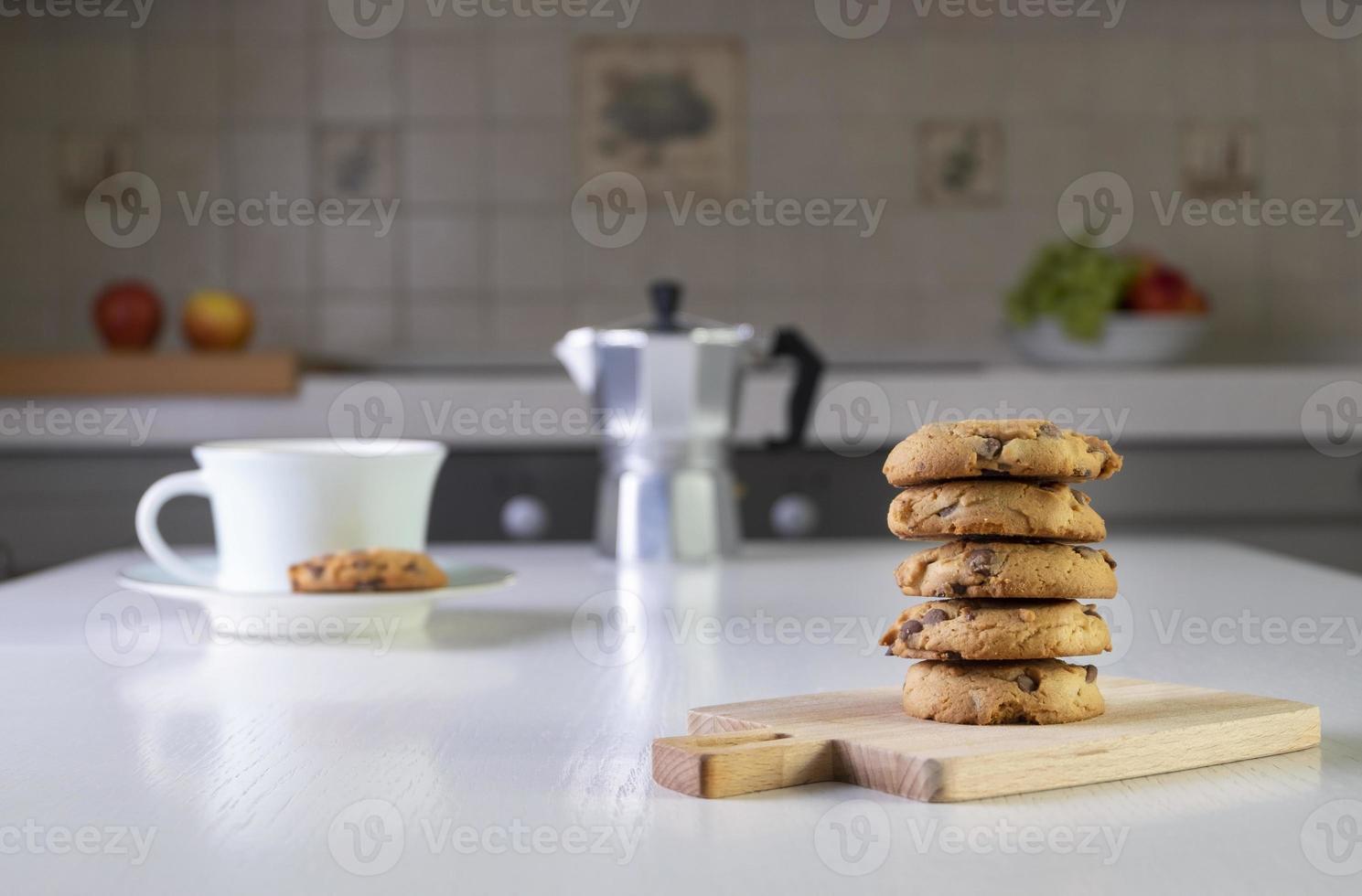 Stack of oatmeal cookies with chunks of chocolate lies on table photo