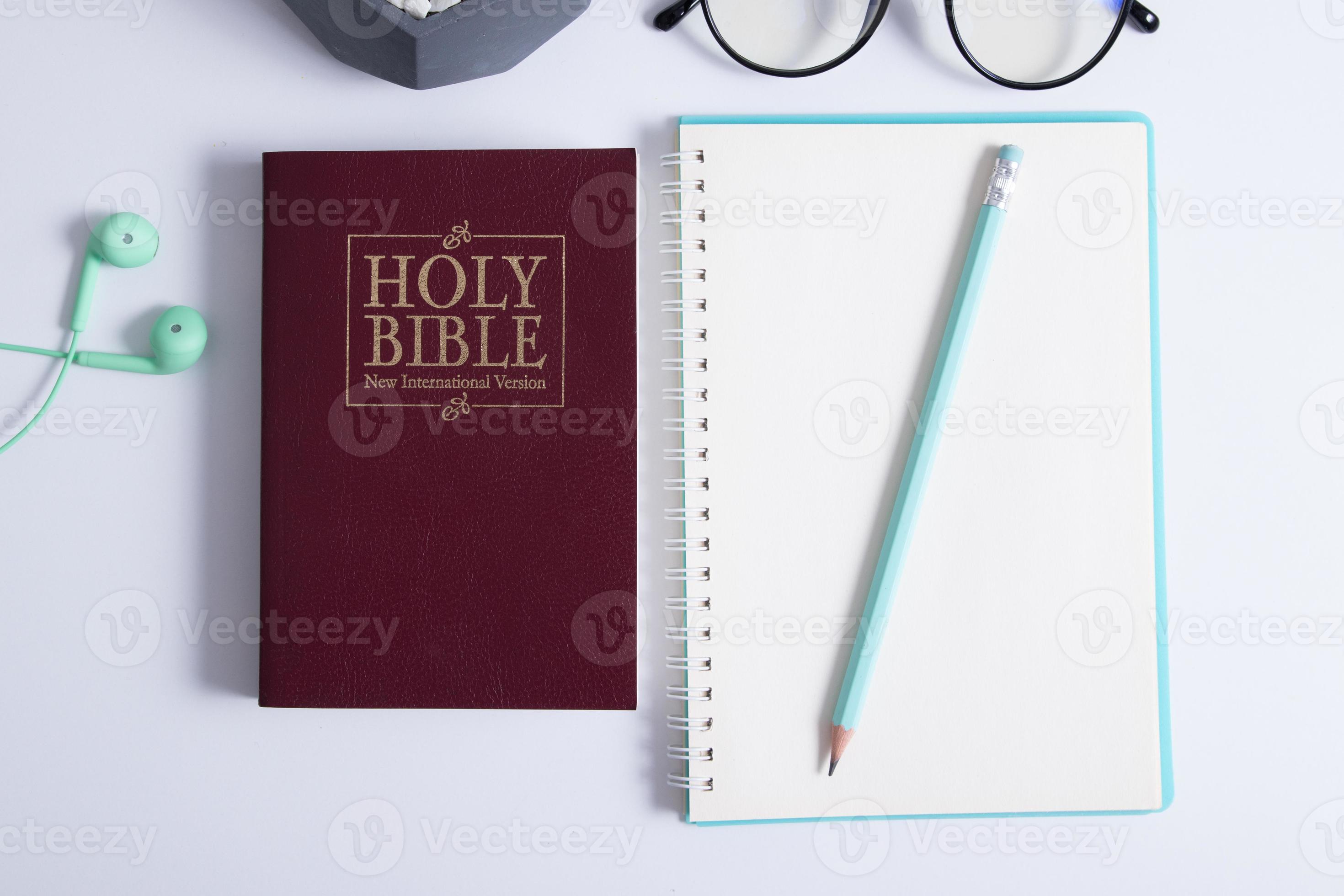 Bible and laptop on the work table with headphones. Bible Study