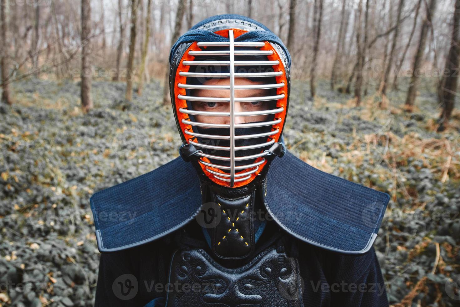 Portrait of man kendo fighter on forest background photo