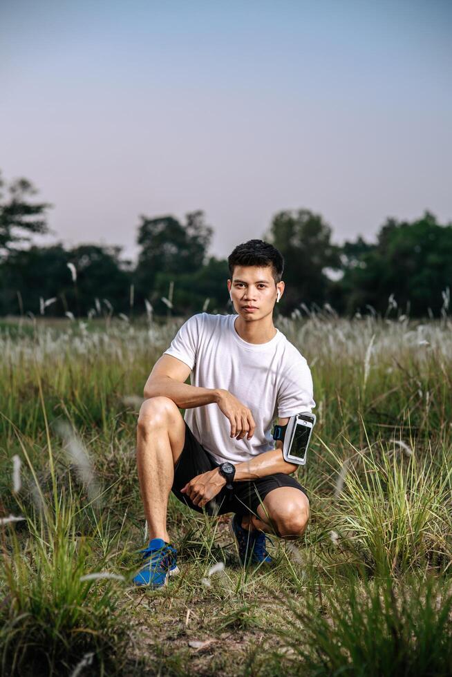 Men sitting and resting after exercising on the roadside. photo