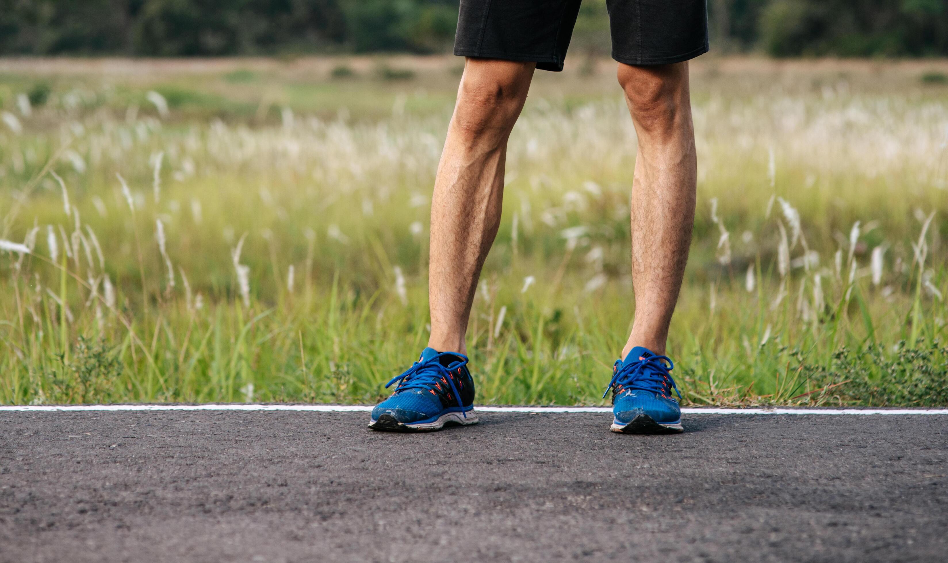 Runner man feet running on road closeup on shoe. Sports healthy ...