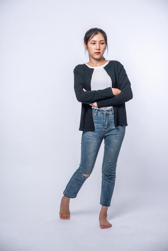 A young woman in a white shirt with arms folded. photo