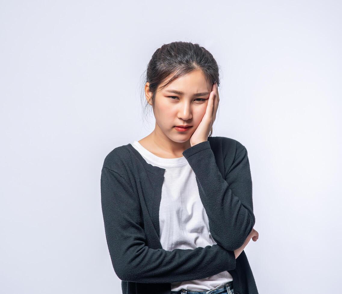 A sick woman with a headache and put her hand on her head photo