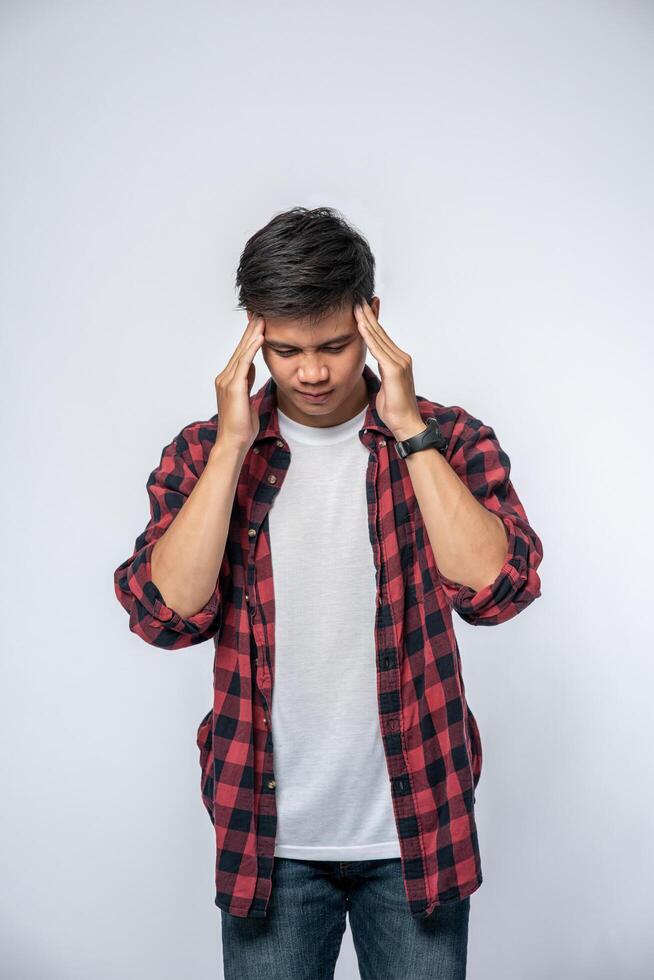 A man who is sick and touches his head with his hand. photo