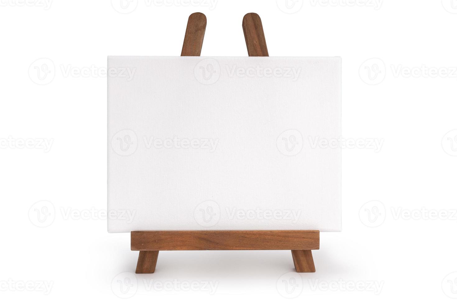 Wooden easel with blank canvas isolated on white background photo