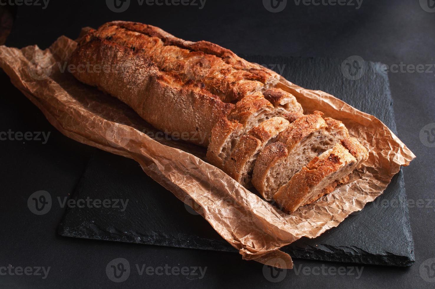 baguette of buckwheat flour without yeast on a black background photo