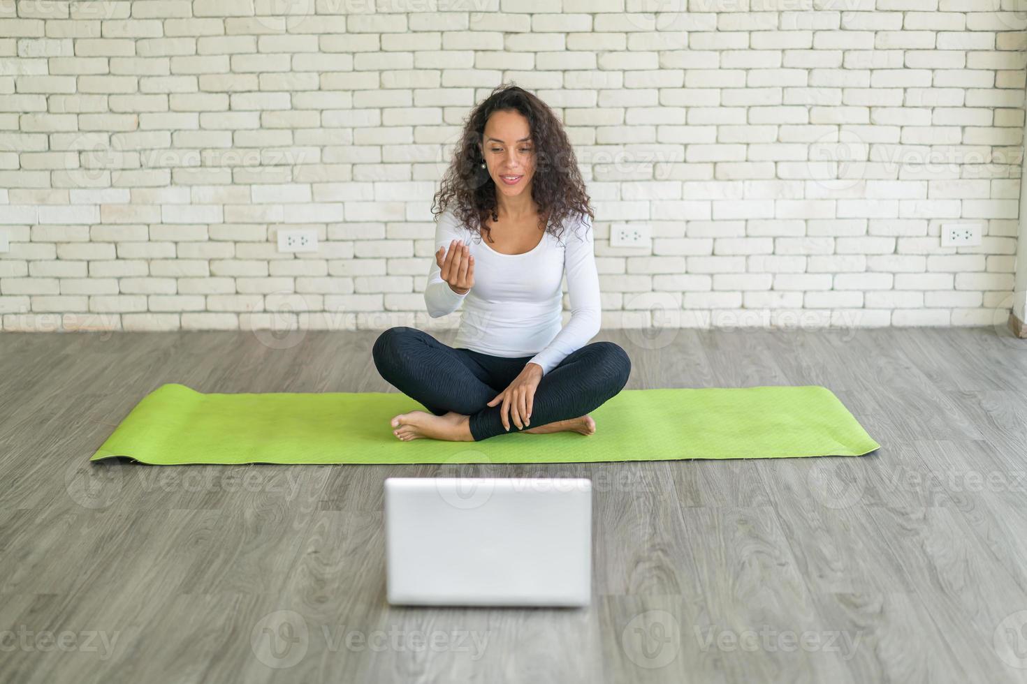 Latin woman teaching yoga online photo