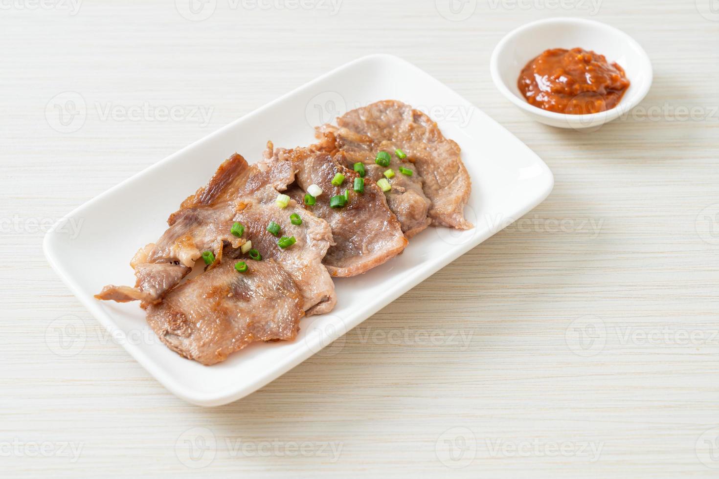 grilled pork neck sliced on plate photo
