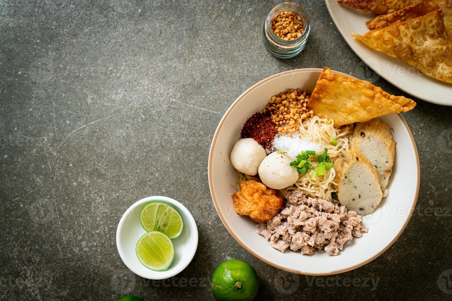 spicy egg noodles with fish balls and shrimp balls without soup photo