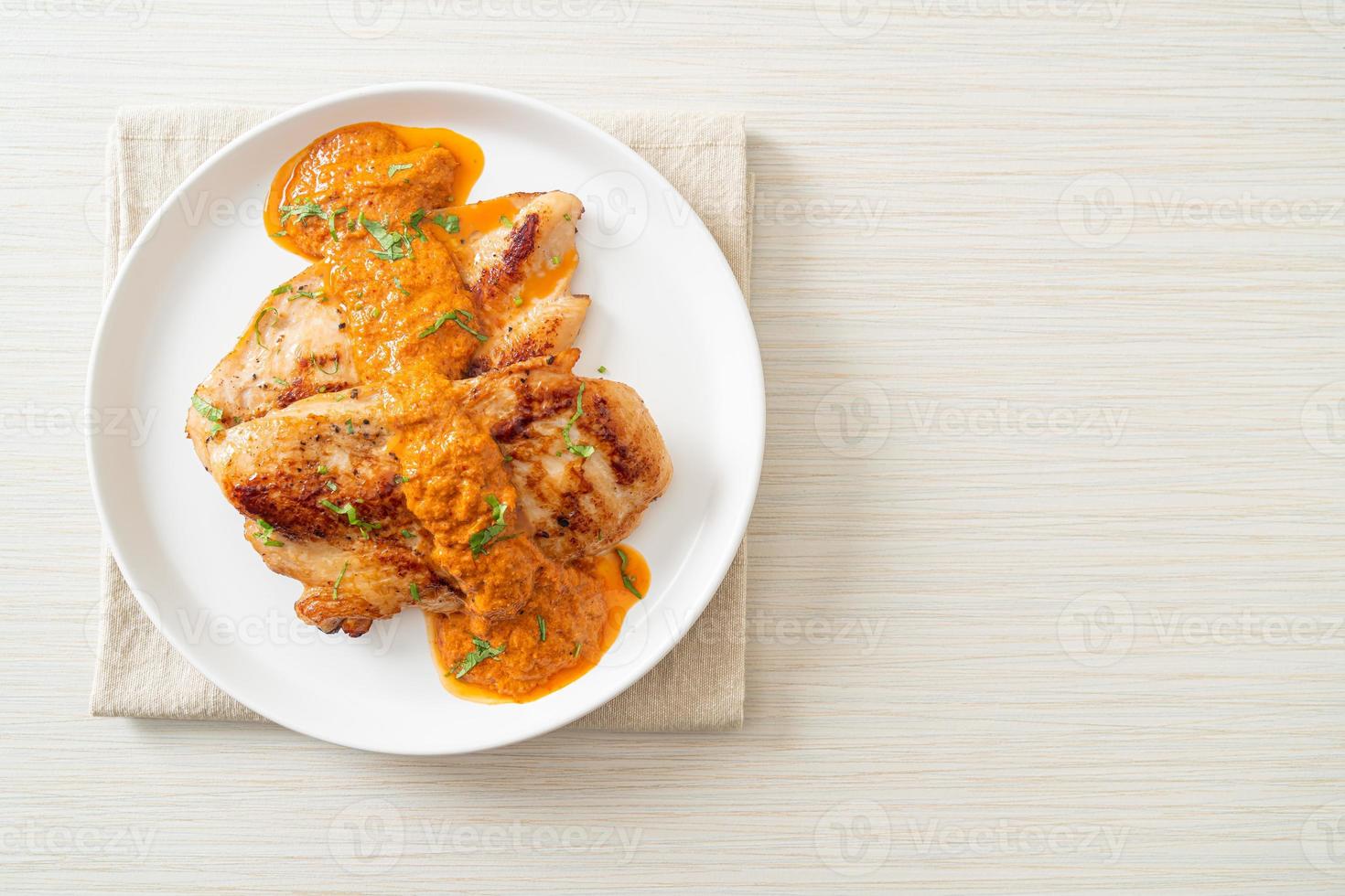 grilled chicken steak with red curry sauce photo