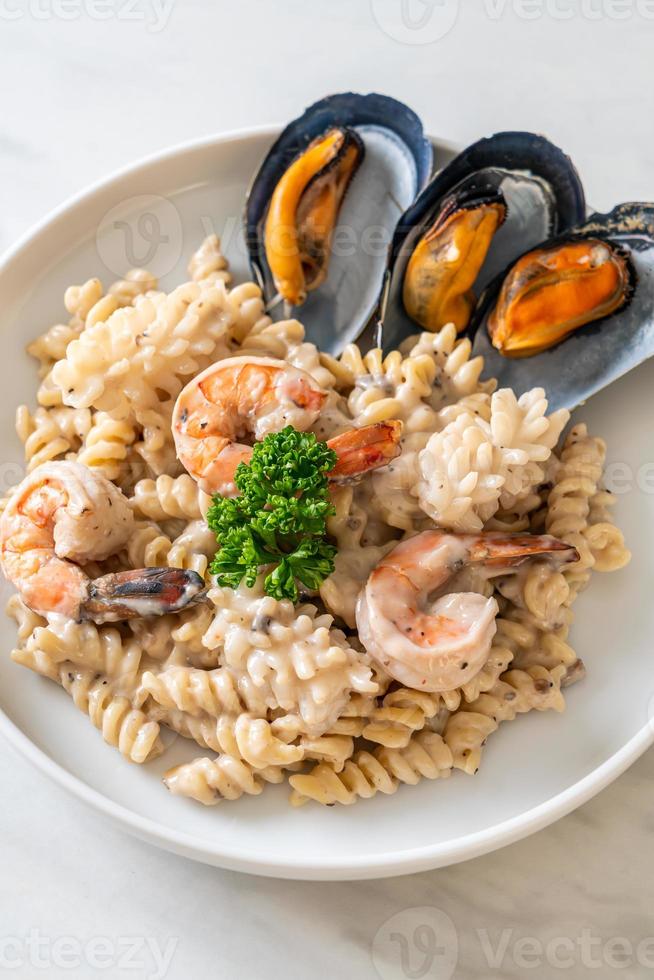 spiral pasta mushroom cream sauce with seafood photo