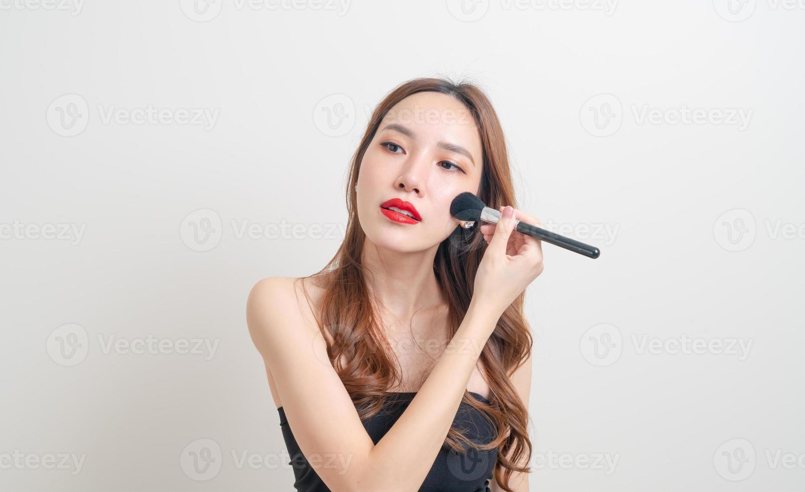 portrait beautiful woman with makeup brush photo