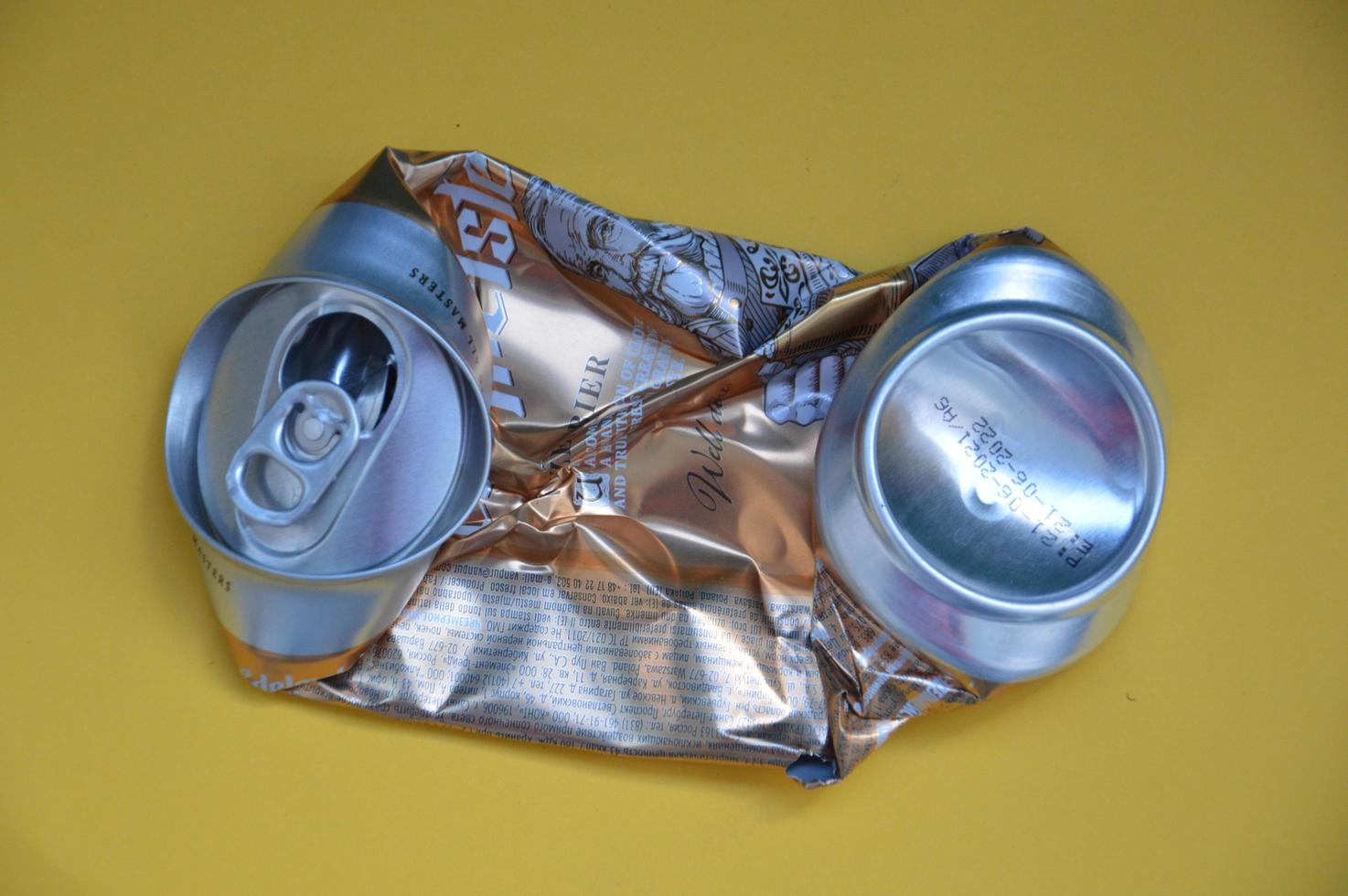 KIEV, UKRAINE - DECEMBER 22, 2021 Crumpled beer cans for scrap photo