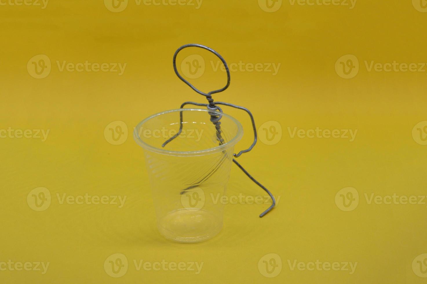 Human figure made of metal wire with an object photo