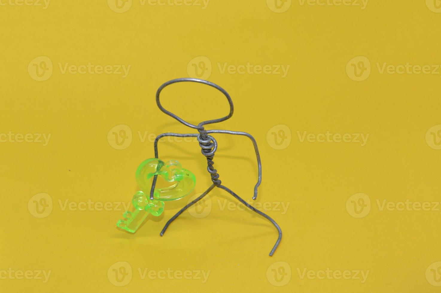 Human figure made of metal wire with an object photo