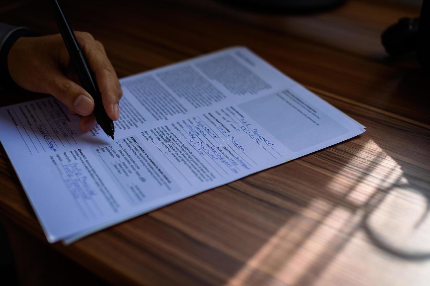 businessman reading and writing documents at work photo