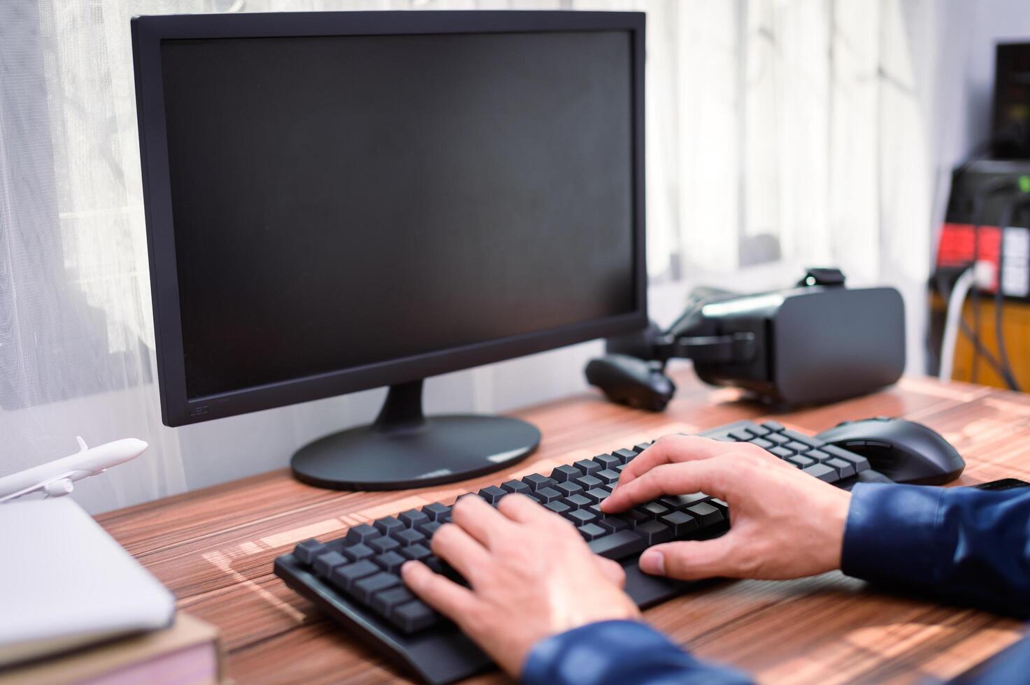 A person typing on a keyboard and computer photo