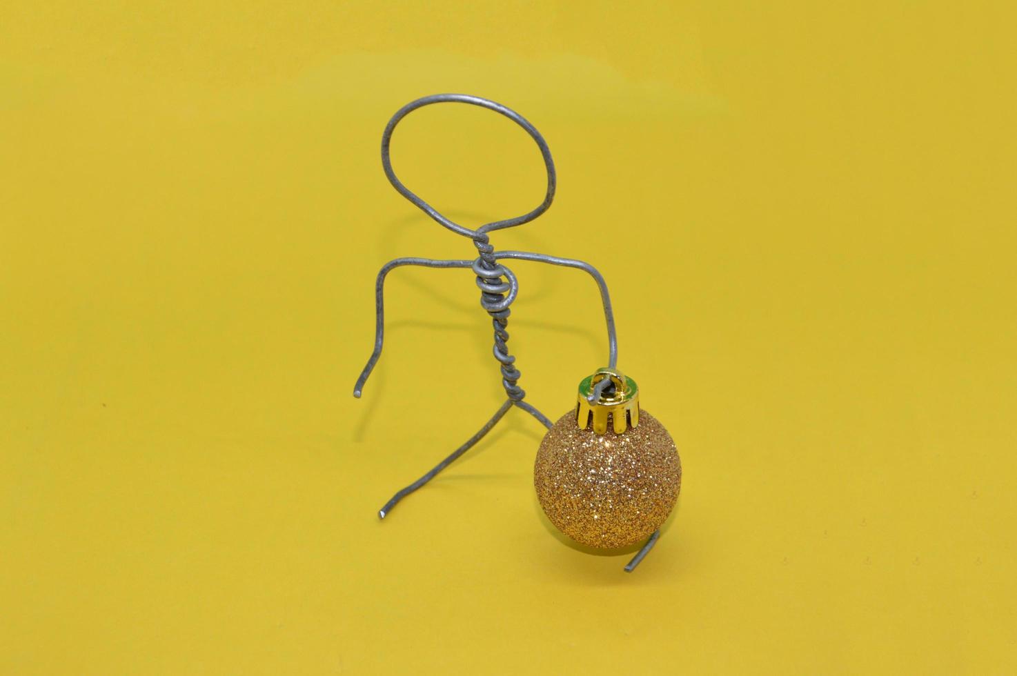 Human figure made of metal wire with an object photo