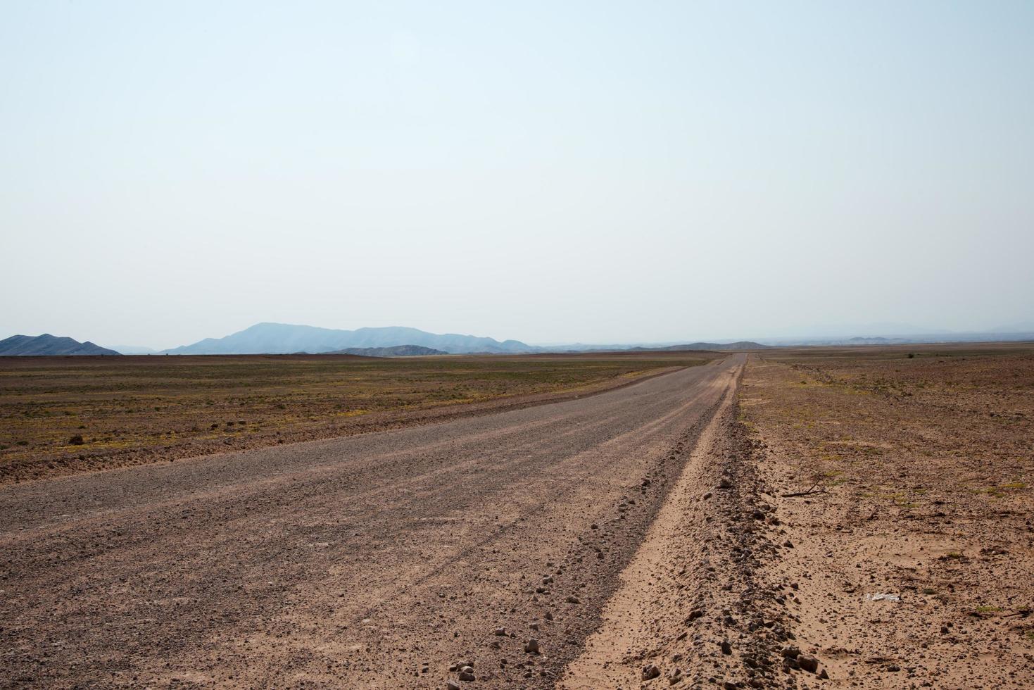 Sandy empty road crossing the namibian desert. Namibia photo