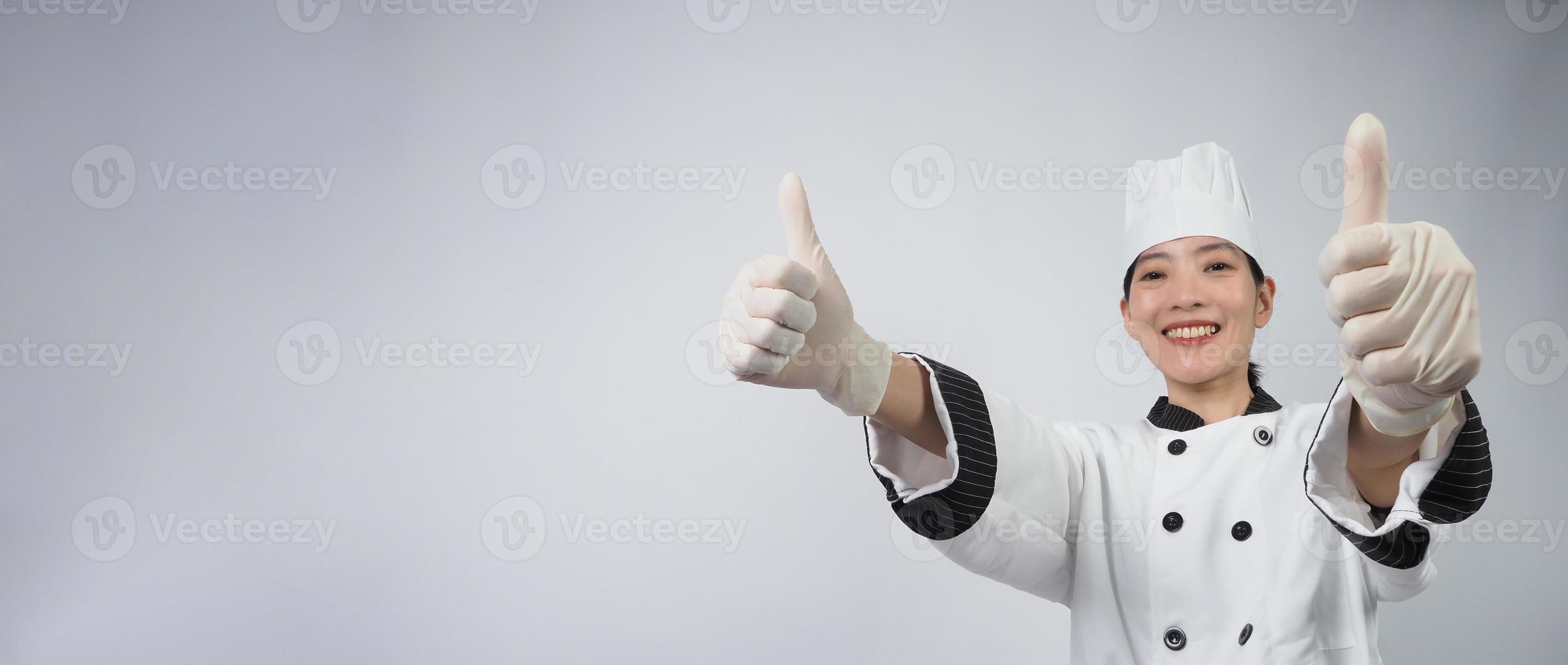 Asian woman chef holding smartphone or digital tablet and received order from online photo