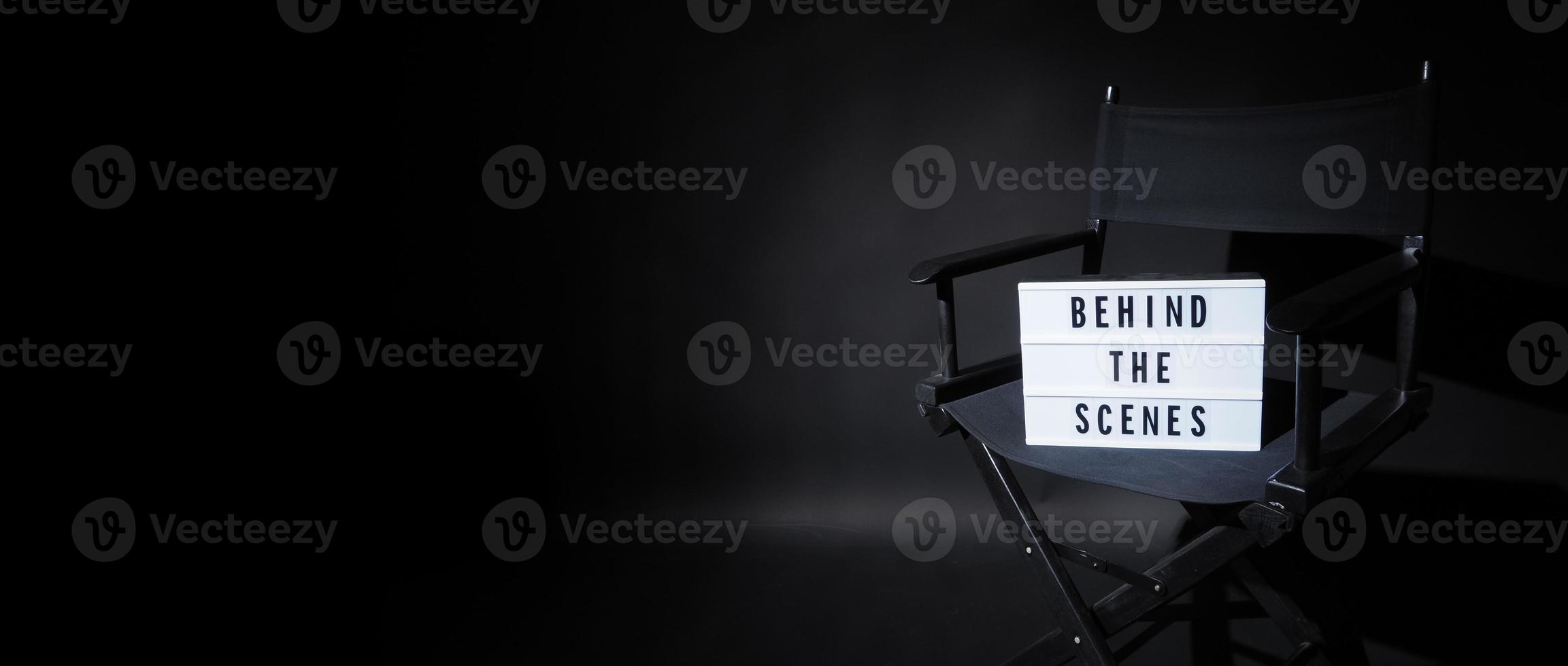 Director chair with behind the scene banner light box. photo