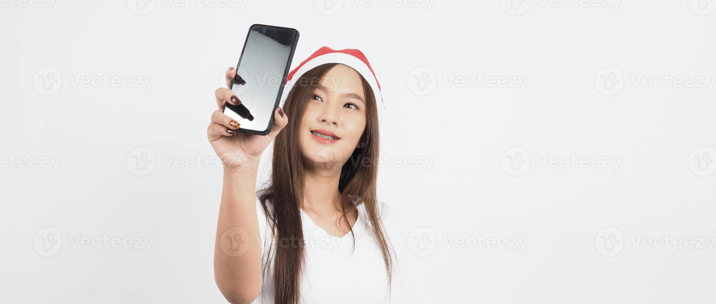 Asian woman with smartphone in hand which posing like selfie or video call photo