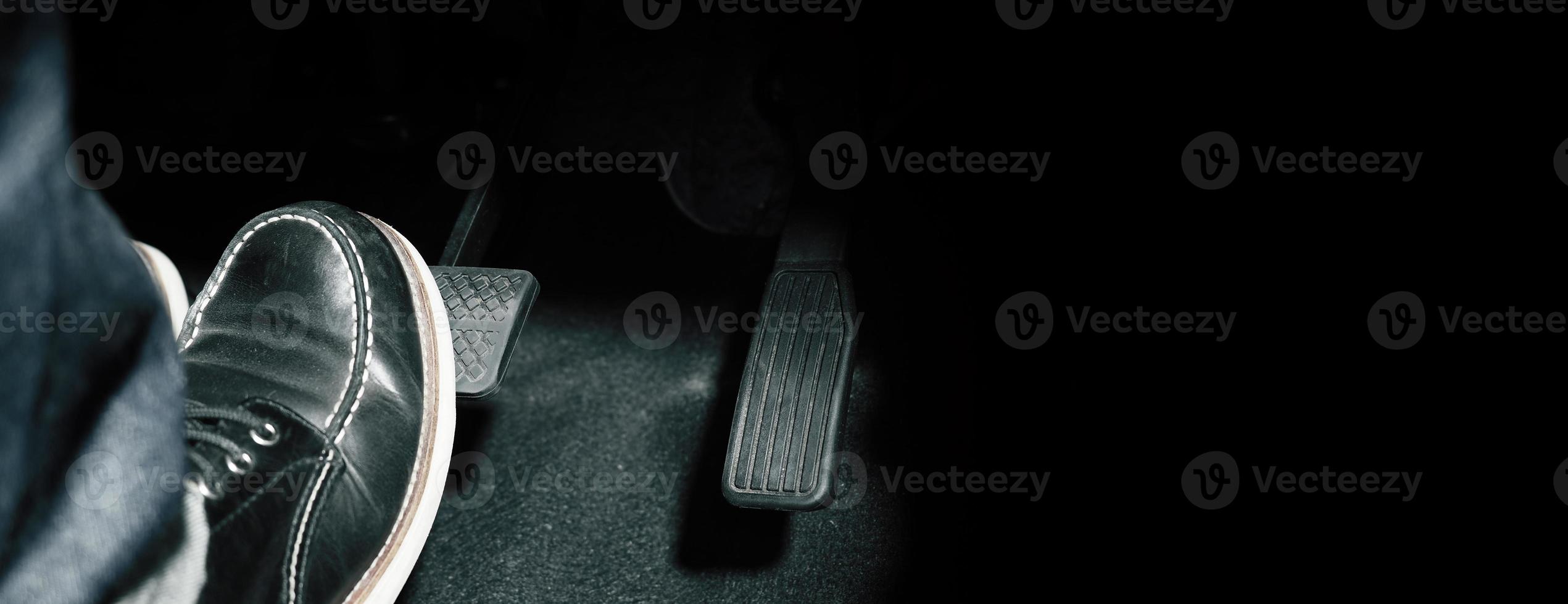 Close up the foot pressing foot pedal of a car to drive ahead. photo