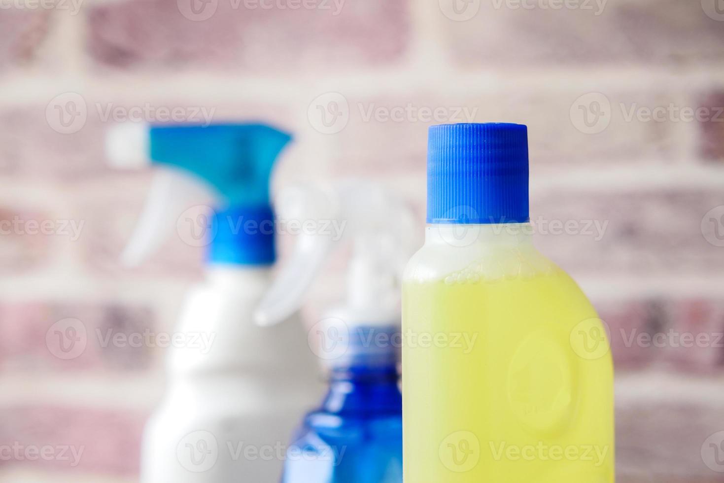 floor cleaning disinfect bottle against brick wall photo