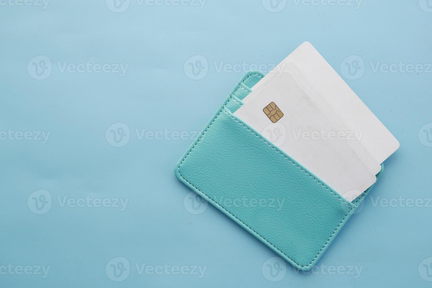 close up of credit cards in a wallet on light green background photo