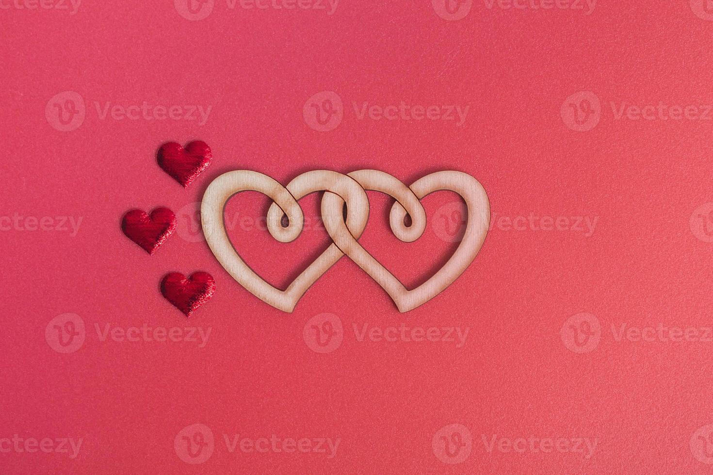 Wooden double heart on a red background copy space. Love concept, valentine's day photo