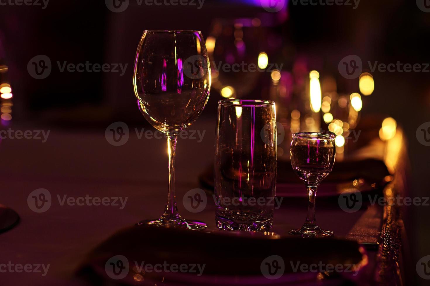 wine glasses on table on dark background. Wine glasses and grapes on stone table photo