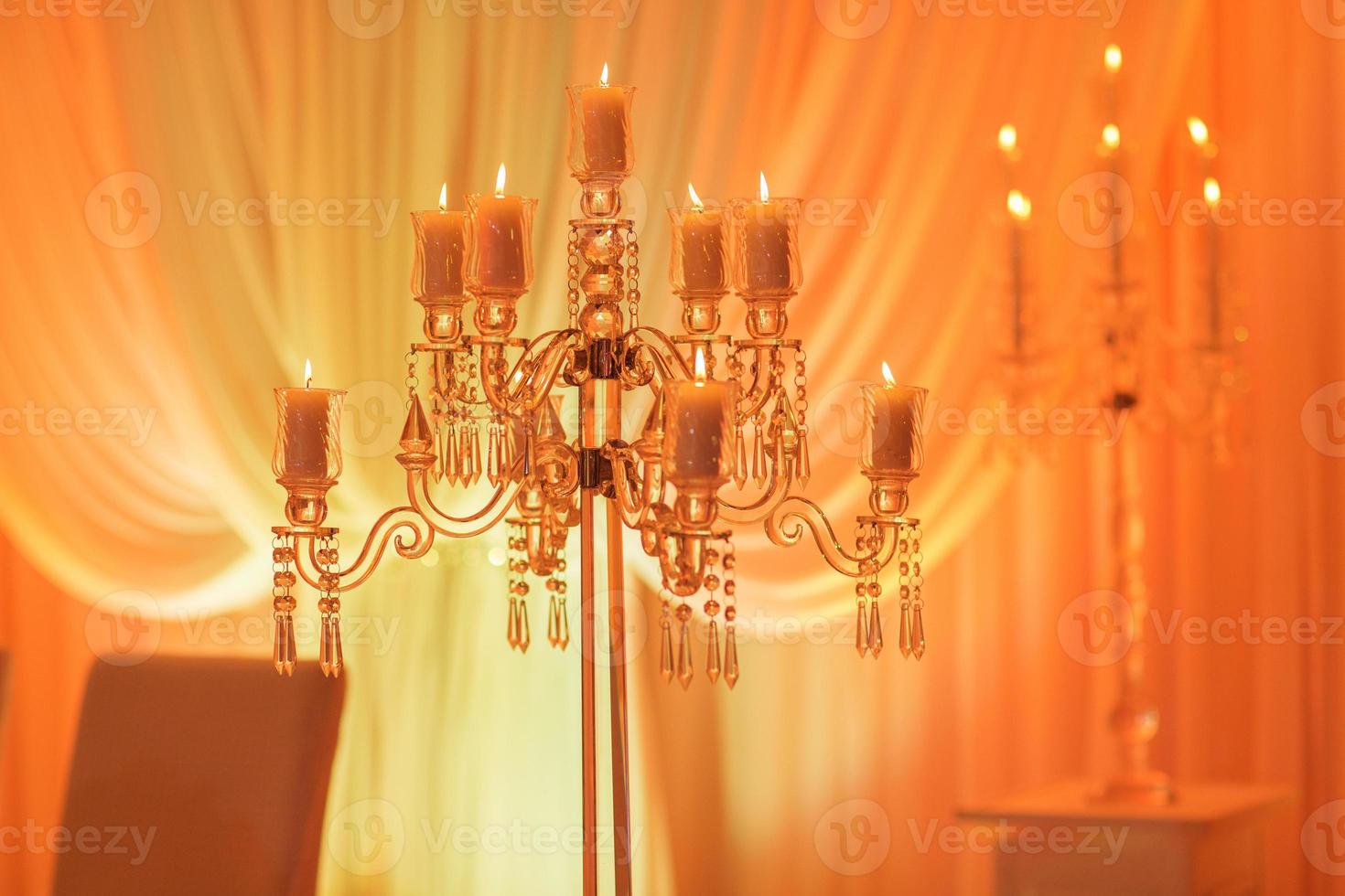 Luxurious wedding table with decor, with silver candlesticks, candles and flowers in blue light. Selective photo