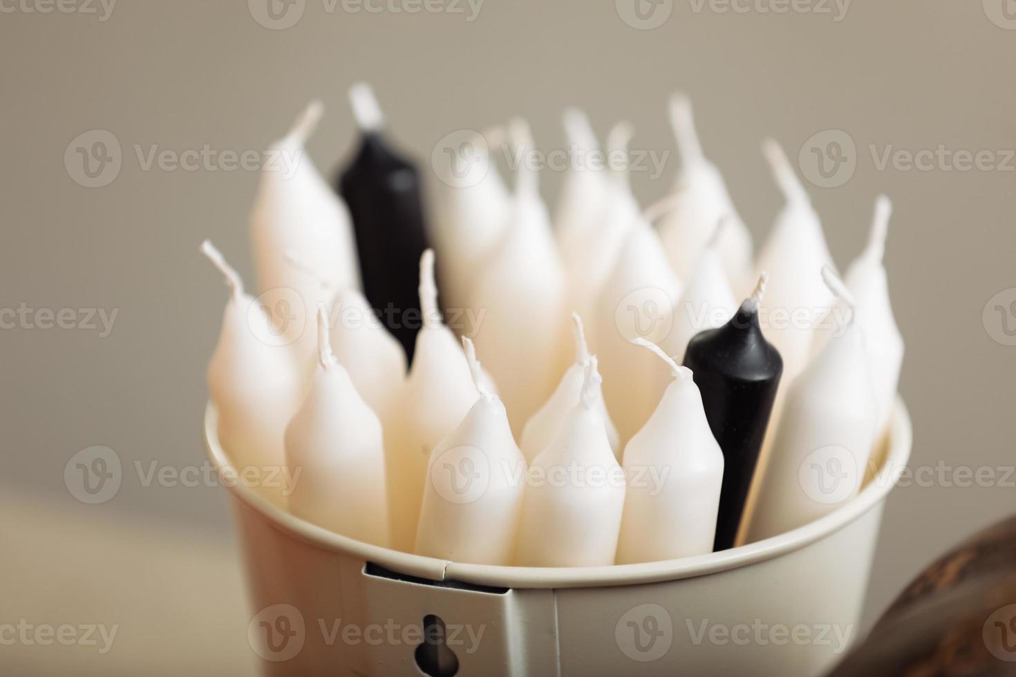 White candle on table, home interior decorations. bucket with candles. selective focus. photo