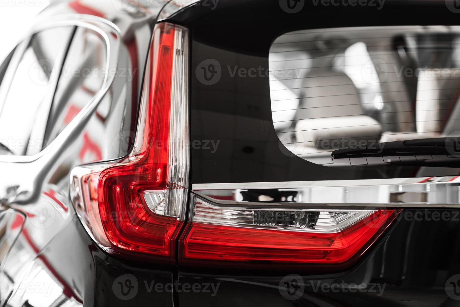 Modern luxury car close-up. Concept of expensive, sports auto. Headlight lamp of new cars,copy space. Luxury red super car details view, elegant and beautiful. Super Car back brake light view, photo