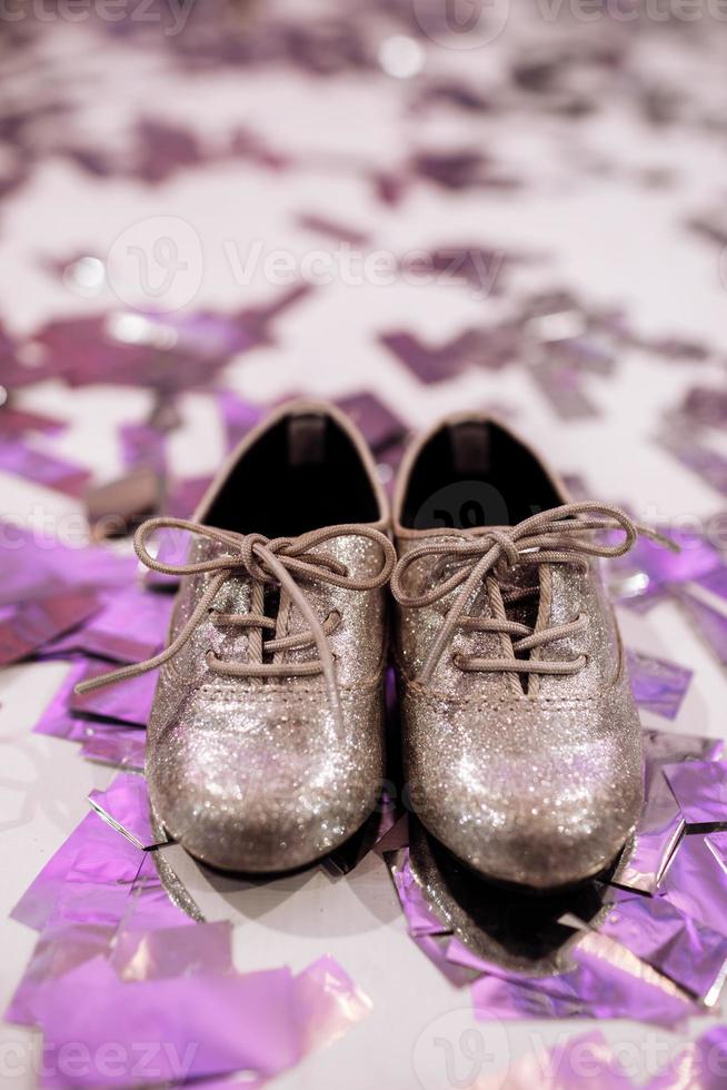 Baby stylish shoes on white background with colorful confetti an copyspace. place for inscription. photo