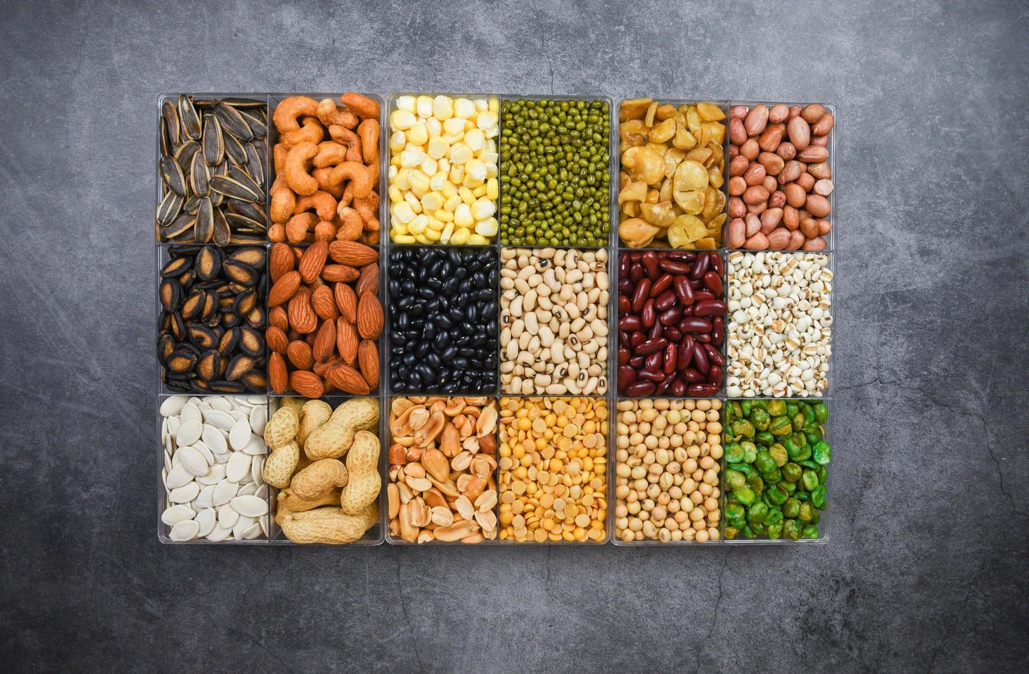 Box of different whole grains beans and legumes seeds lentils and nuts colorful snack background top view Collage various beans mix peas agriculture of natural healthy food for cooking ingredients photo