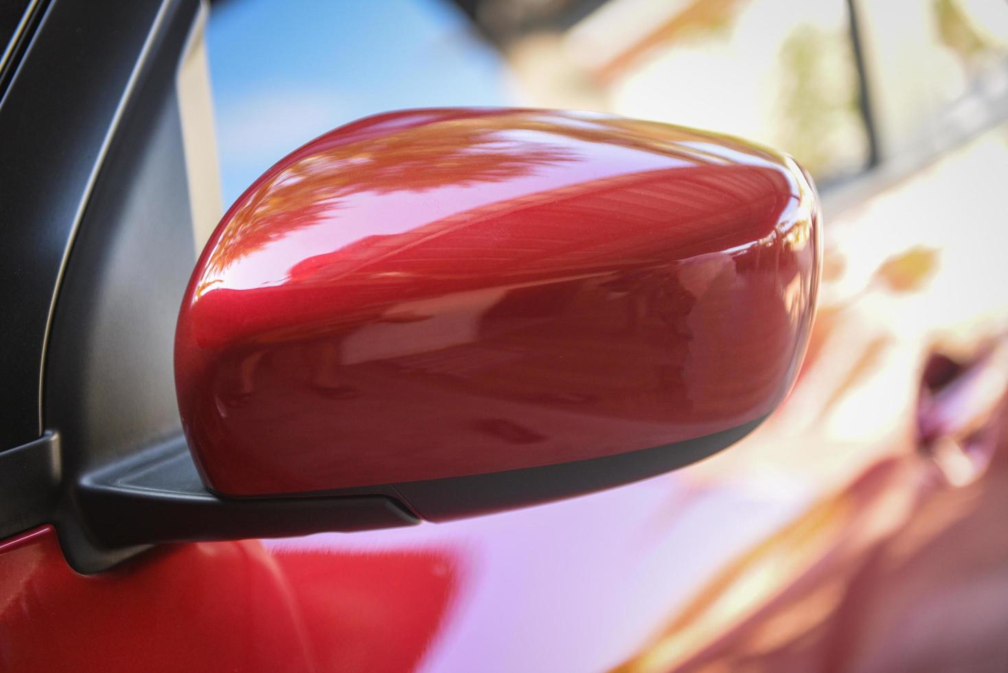 Red car with side rear view mirror on a modern car side mirror front photo