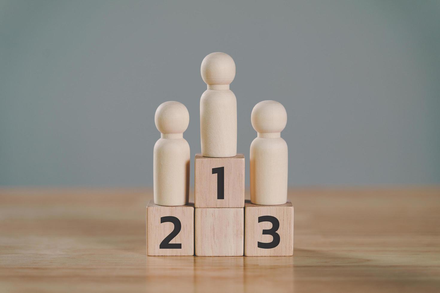 wooden figures peg doll standing on the podium 1st, 2nd, 3rd positions of wooden cube blocks with copy space. ranking and strategy concept. photo