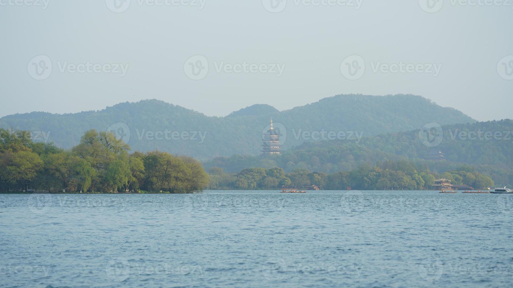 The beautiful lake landscapes in the Hangzhou city of the China in spring with one old temple tower located on the shore photo