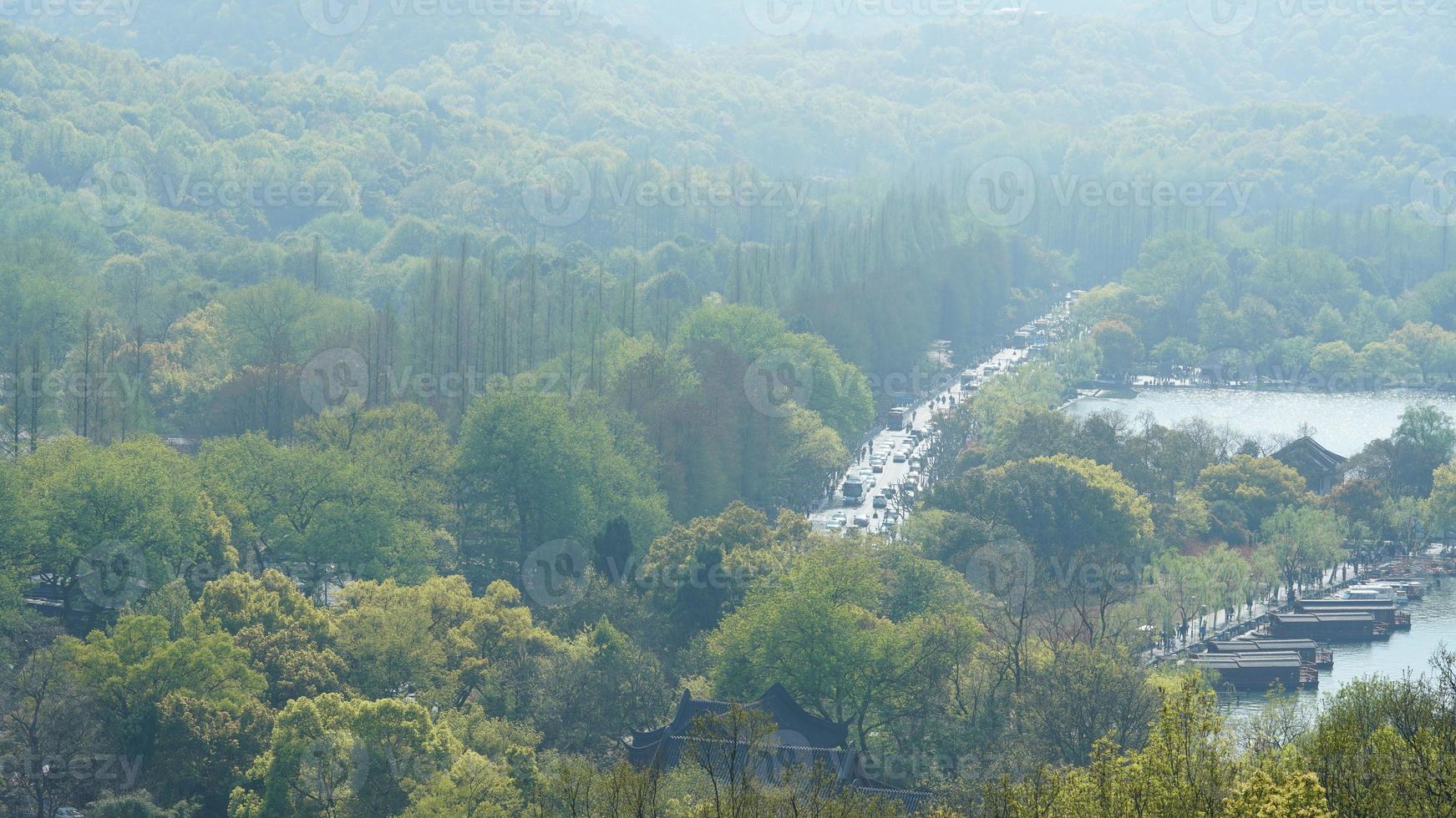 The beautiful lake landscapes in the Hangzhou city of the China in spring with the peaceful lake and fresh green mountains photo