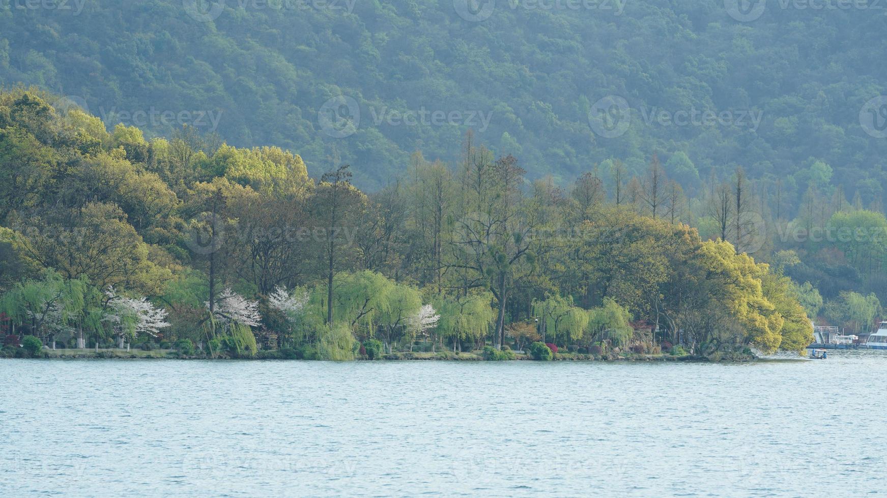 los hermosos paisajes lacustres en la ciudad china de Hangzhou en primavera con el lago tranquilo y las montañas verdes frescas foto