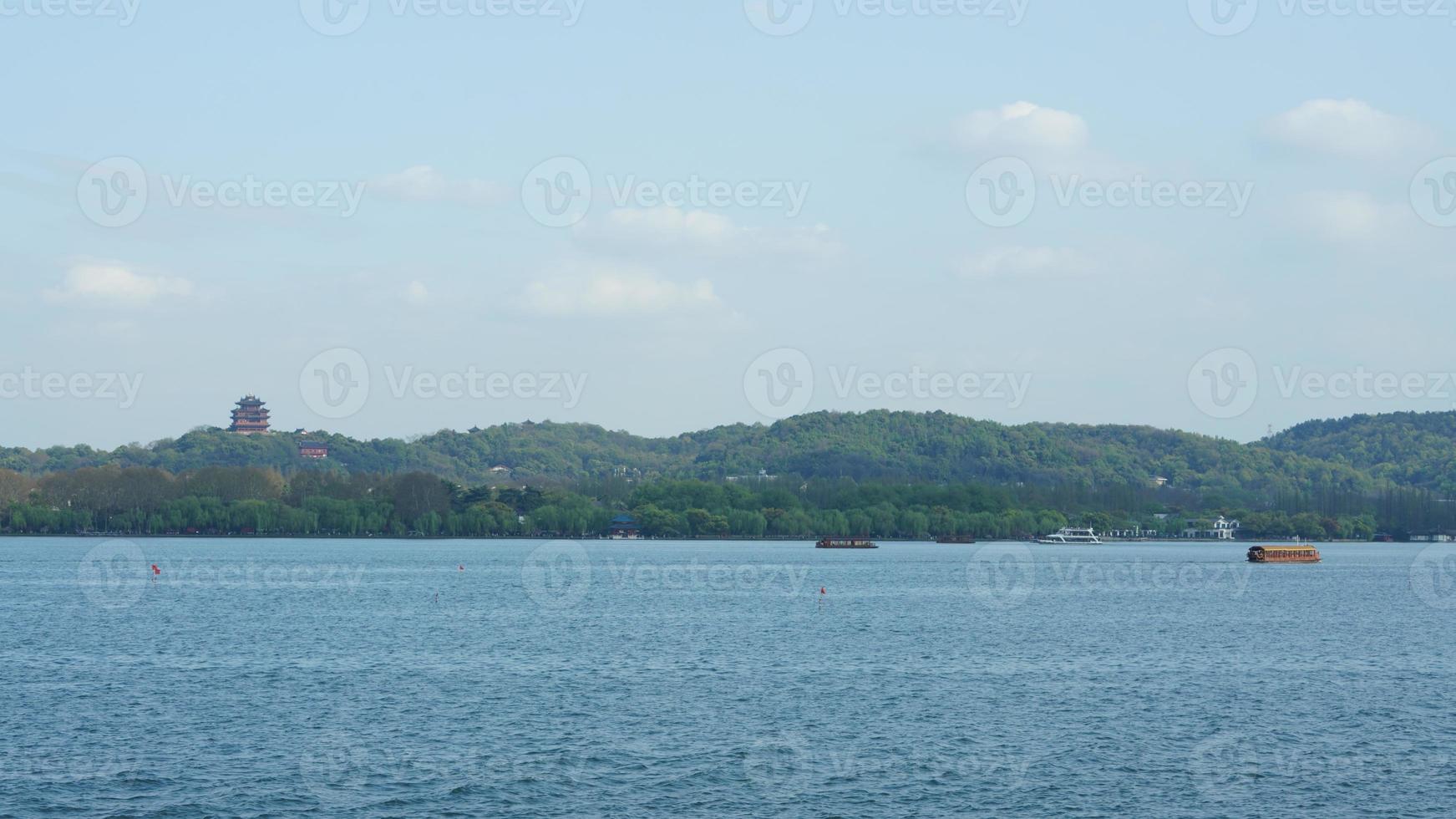 The beautiful lake landscapes in the Hangzhou city of the China in spring with the peaceful lake and fresh green mountains photo