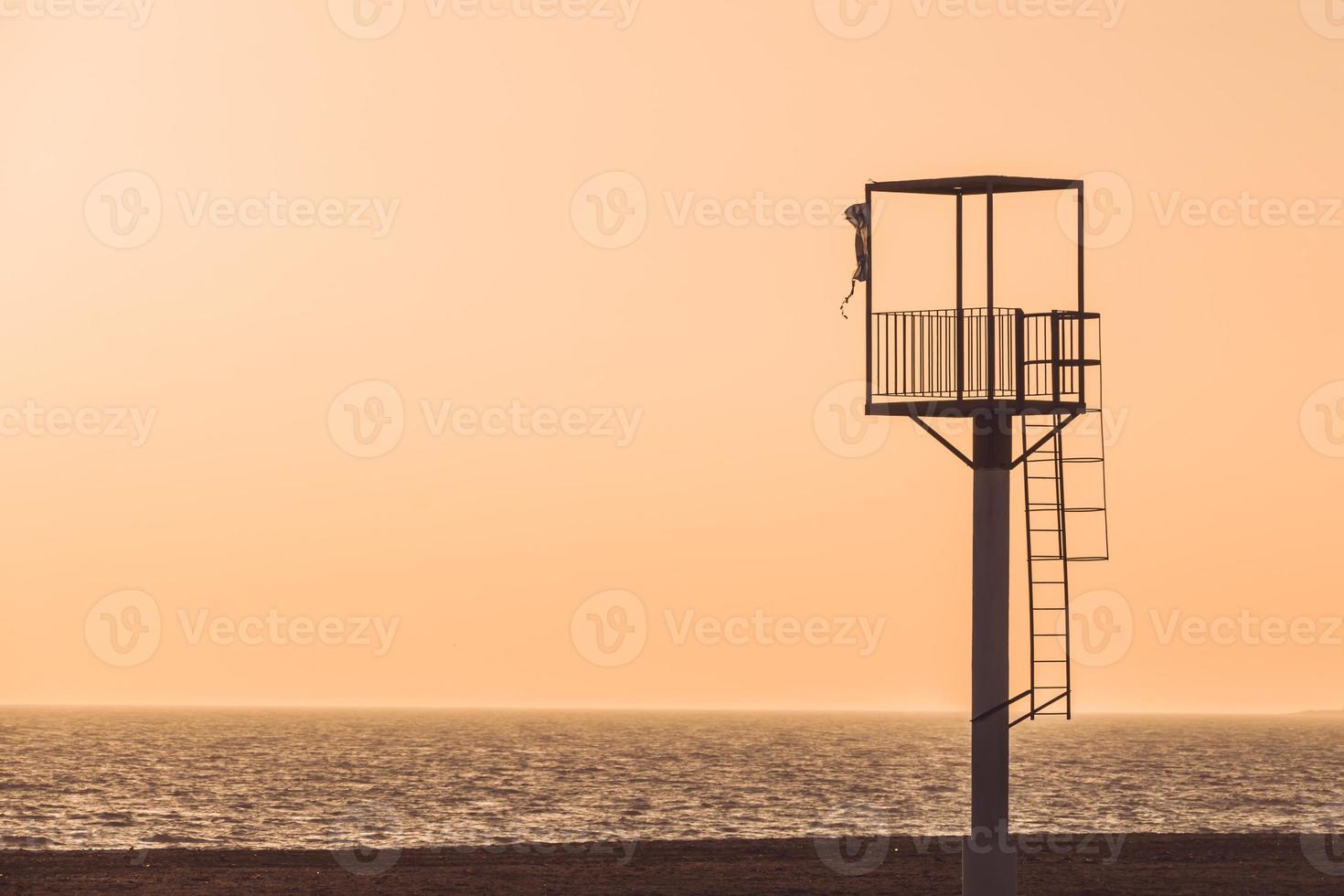Almerimar beach lifeguard tower at sunset. Deserted beach, no people. Almeria, Andalusia, Spain photo
